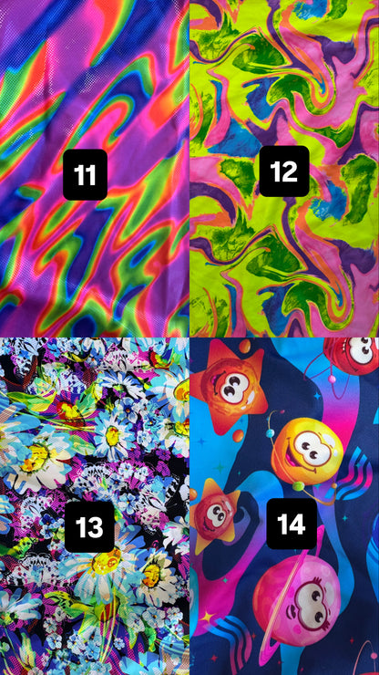 A 2x2 grid showing four colorful psychedelic fabric or print options, labeled 11, 12, 13, and 14. The top-left design has neon pink, blue, green, and yellow swirls; the top-right has neon green, pink, and purple marbled swirls; the bottom-left has a black background with white, blue, and yellow flower-like shapes; the bottom-right has a dark blue background with cartoon planets and orange/yellow celestial shapes.