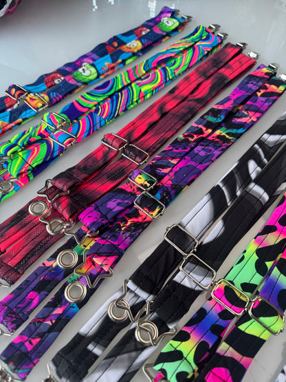 A close up with details of the Magic Utility backpack straps. Includes a silver grommet and silver star attachment points and silver buckles for hands free coat  carrying and more.