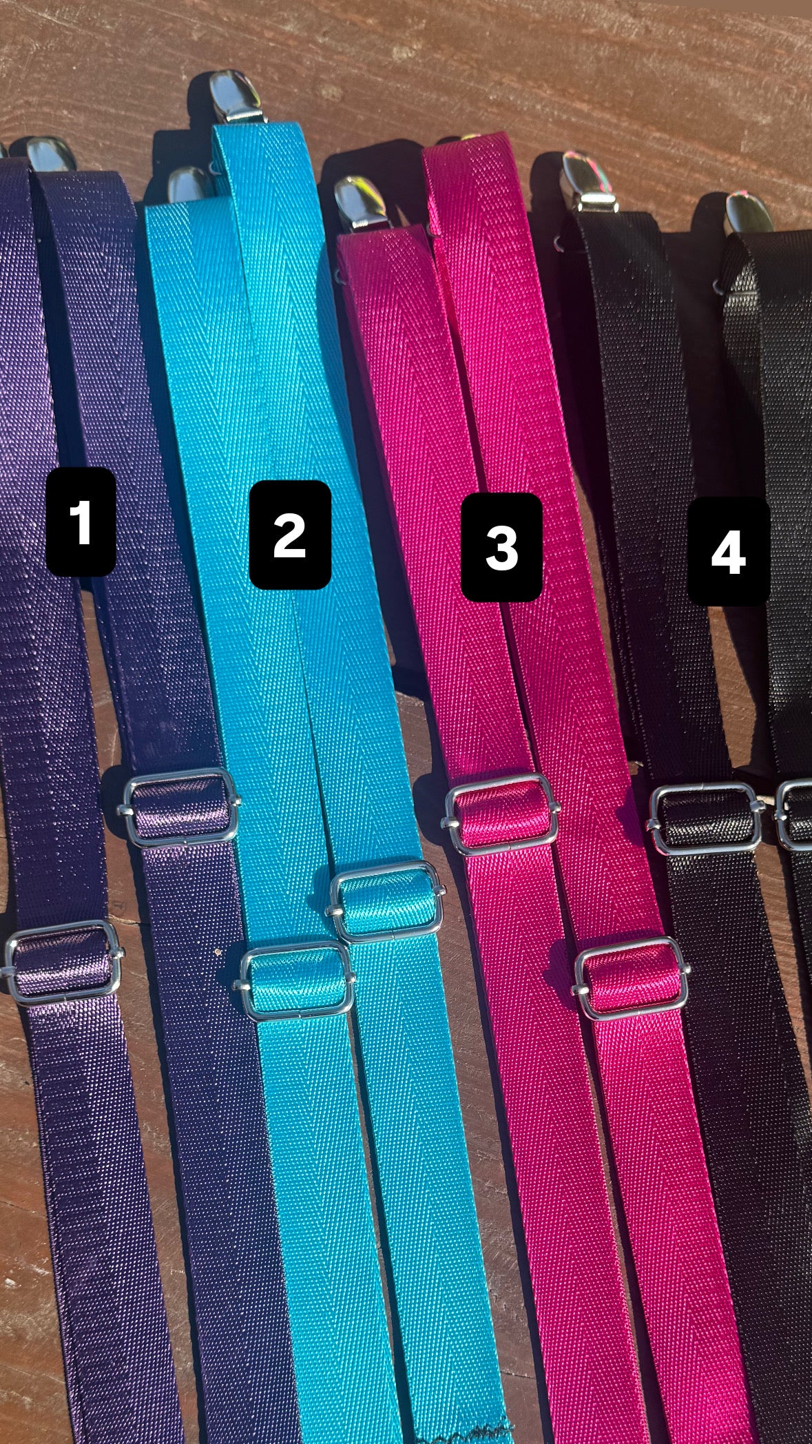 Four pairs of adjustable Backpack Straps in different colors (purple, turquoise, magenta, and black) arranged side-by-side on a wooden surface, with black numbered labels 1, 2, 3, and 4.